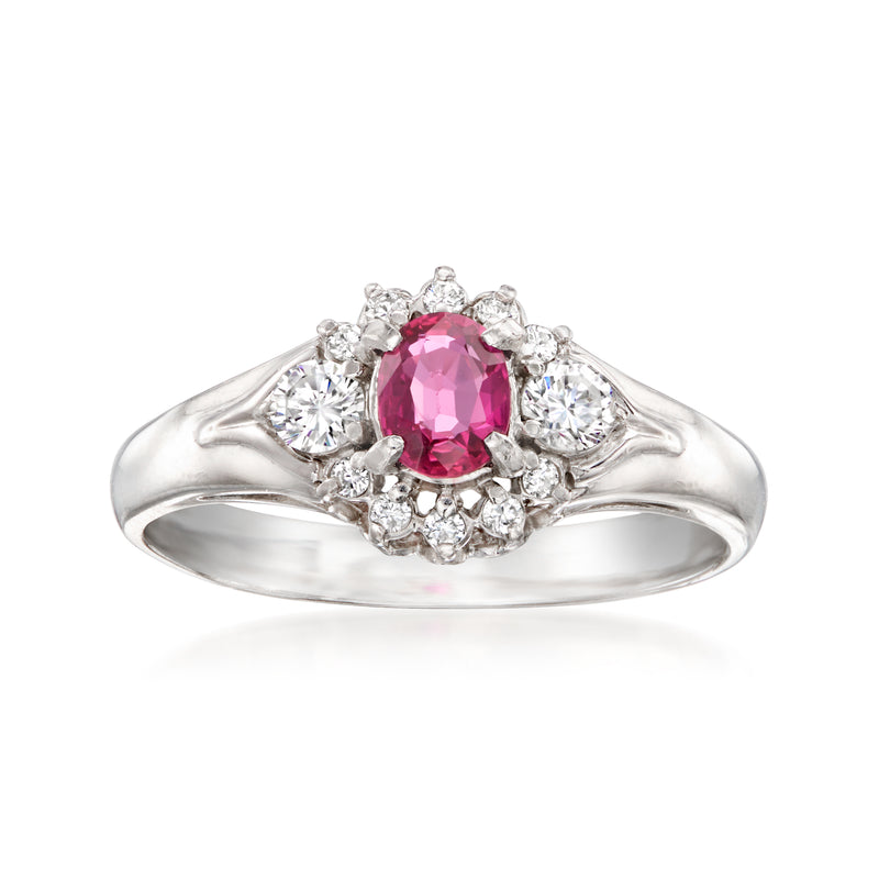 Platinum vintage ring with pink oval ruby center, round diamond halo and split shank