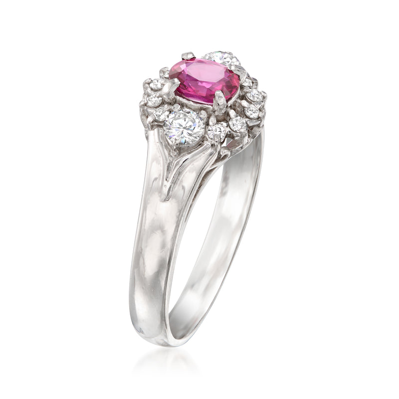 Platinum ring with pink oval ruby in round diamond cluster, contoured band