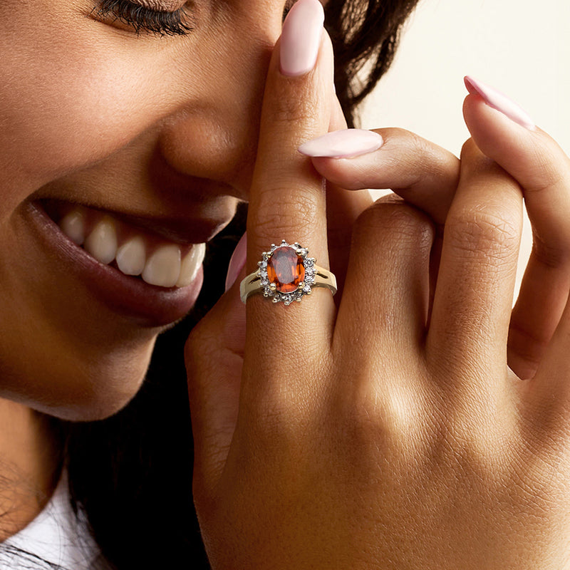 Orange zircon halo diamond ring on hand, 14kt yellow gold, oval centerpiece