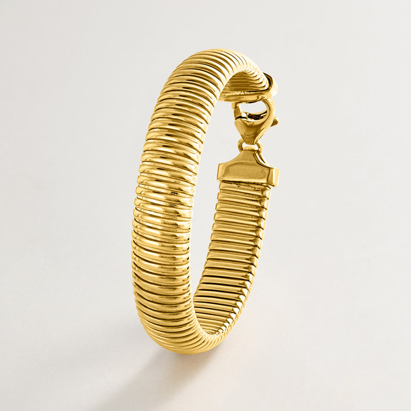 Gold-plated omega bracelet, ribbed coil band with clasp detail
