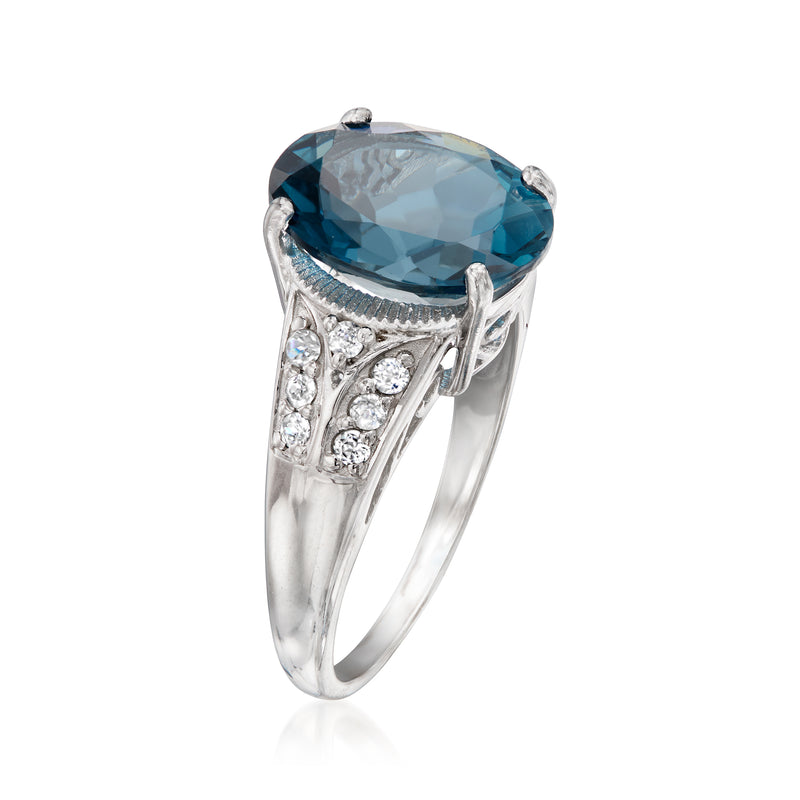 White gold ring with oval London blue topaz and sparkling zircon side panels