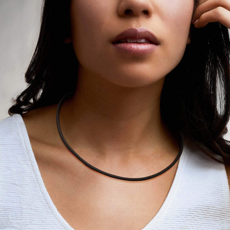 Black leather cord necklace on model, slim choker style
