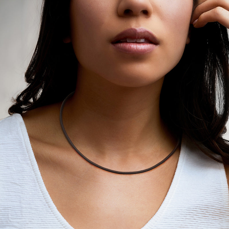 Italian brown leather cord necklace with gold-tone clasp on model neck