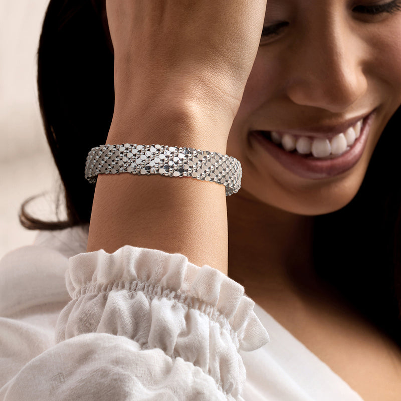 Rhodium-plated patterned cuff bracelet on a woman's wrist