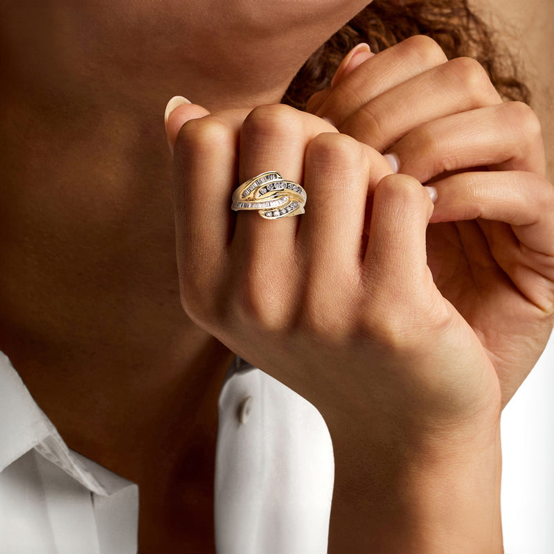Diamond interlocking ring in 14kt yellow gold worn on finger with round and baguette stones