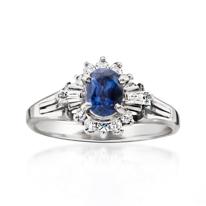Platinum vintage sapphire ring with oval blue center stone and diamond halo
