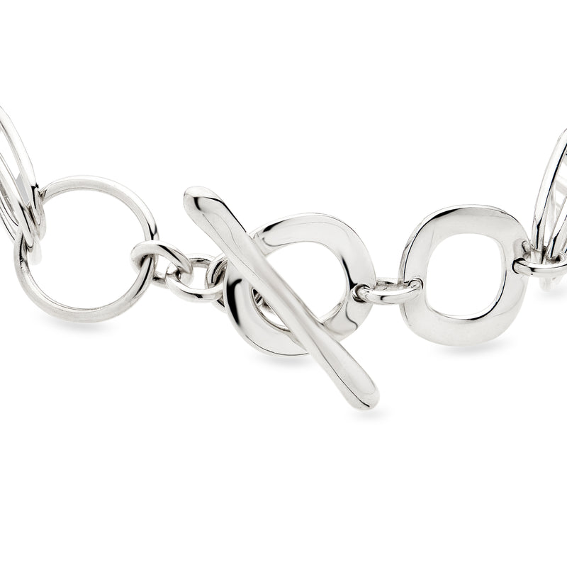 Sterling silver link bracelet with oval rings, hinged bar, and clasp