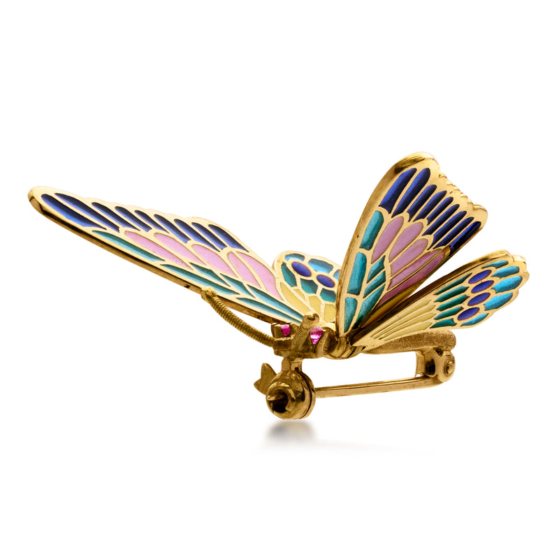 Gold butterfly pin with multicolored enamel wings and small purple gemstone, side view