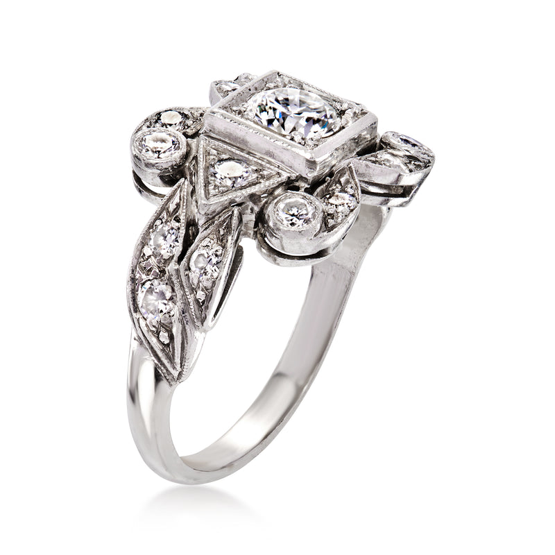 Platinum diamond ring with cushion-cut center and marquise side stones, angled view
