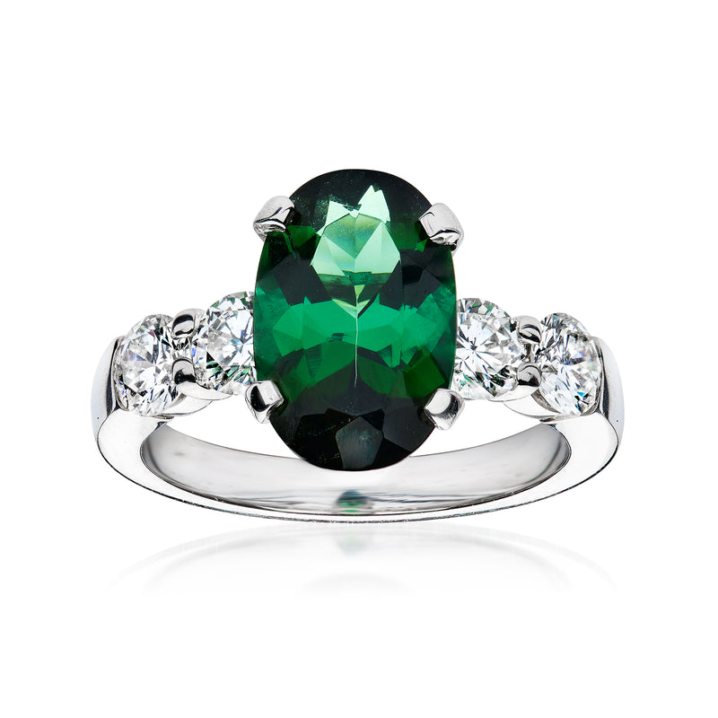 Platinum ring with oval green tourmaline center and round diamond side accents