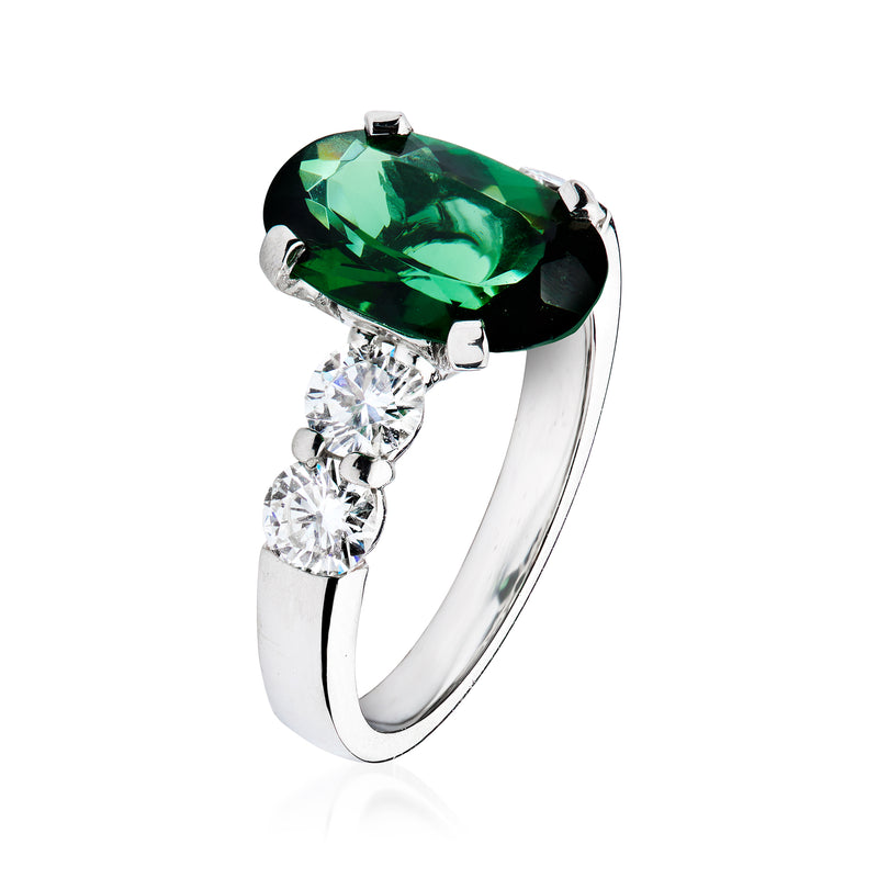 Platinum ring with large oval green tourmaline and three round diamond accents