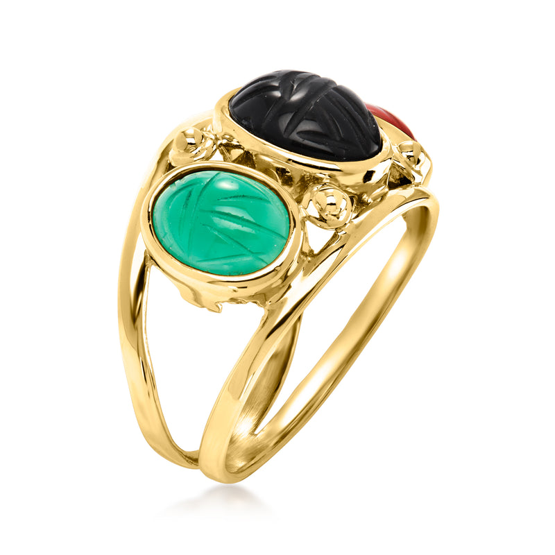 Yellow gold oval green gemstone ring with black oval centerpiece and red side stone