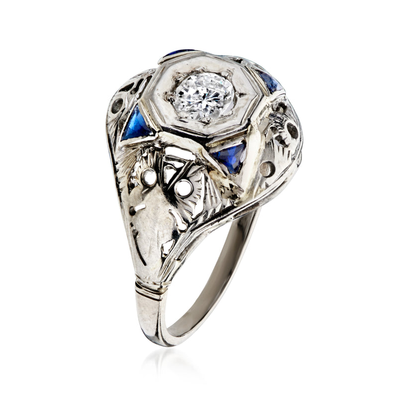 Vintage diamond filigree ring in white gold with round center stone and blue side stones