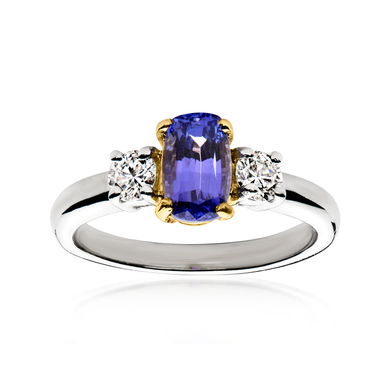 Tanzanite ring with oval blue gemstone, diamond side stones, platinum band and gold setting