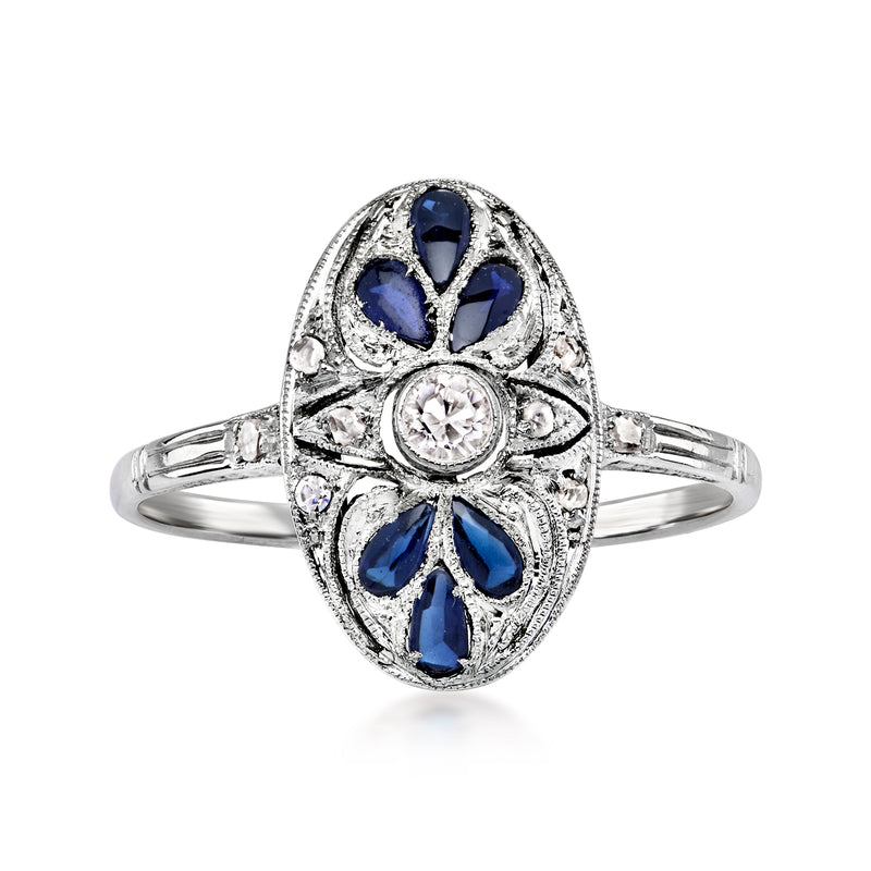 Platinum vintage ring with oval blue center sapphire and diamond accents, geometric setting