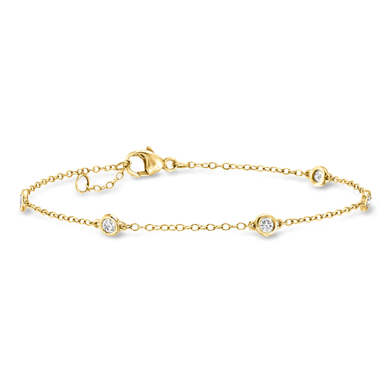 10kt yellow gold diamond station bracelet with three round bezel-set stones