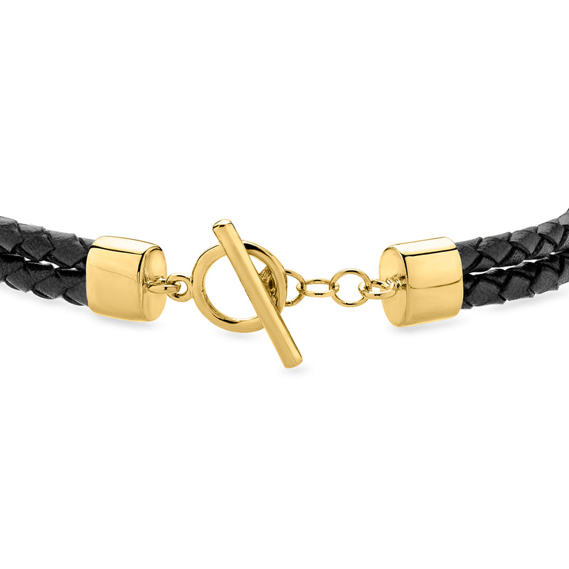 Black braided leather bracelet close-up of gold-tone toggle and end caps