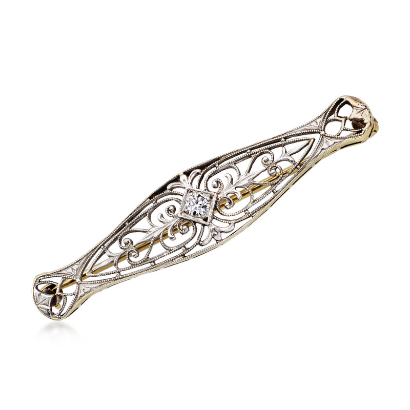 Vintage openwork pin in platinum and 14kt yellow gold, with a single diamond