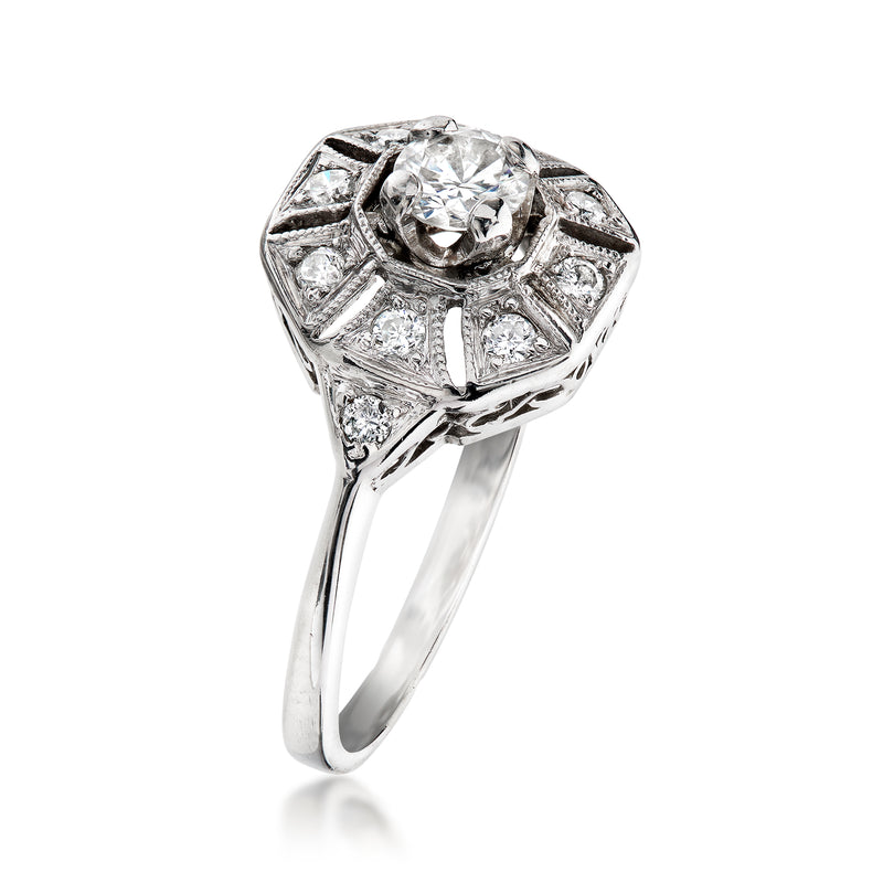 Vintage white gold diamond ring with large round center stone and faceted side details