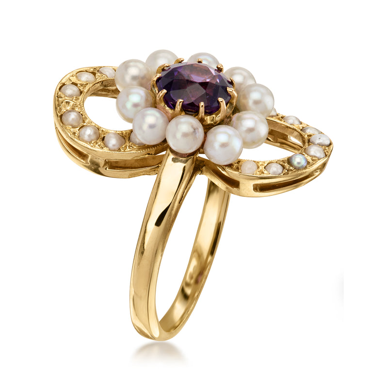 Gold ring with oval purple amethyst set in bezel, surrounded by pearls and pave
