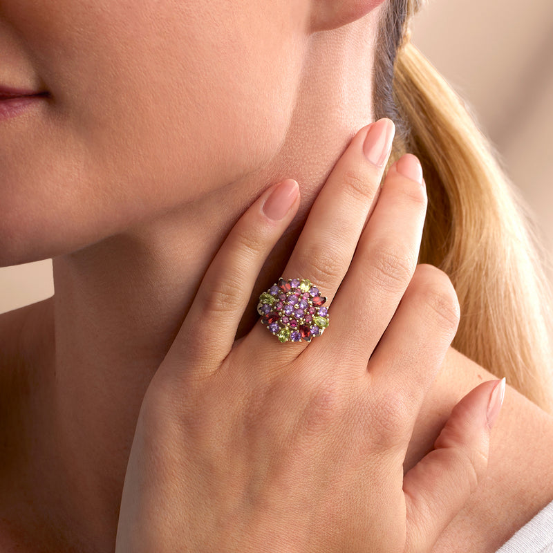 Vintage yellow gold cluster ring with purple, pink, red, and green stones on hand