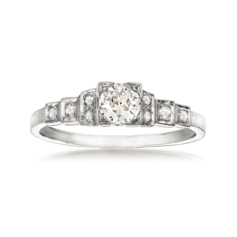 Vintage platinum diamond ring with cushion-cut center and step-set baguette diamonds
