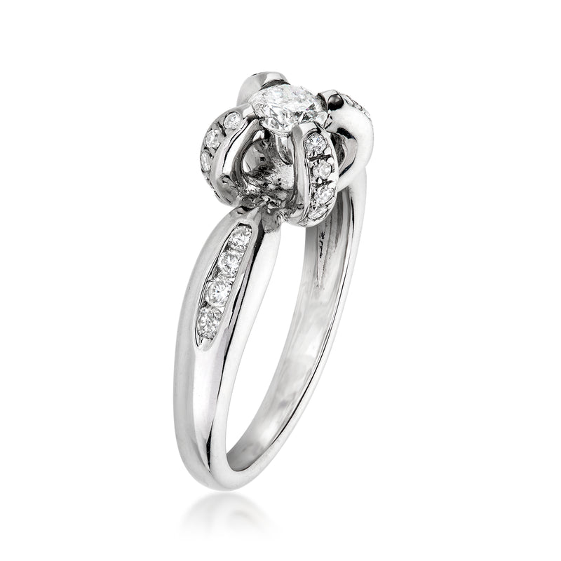 White gold diamond ring with raised prong-set center stone and curved side settings
