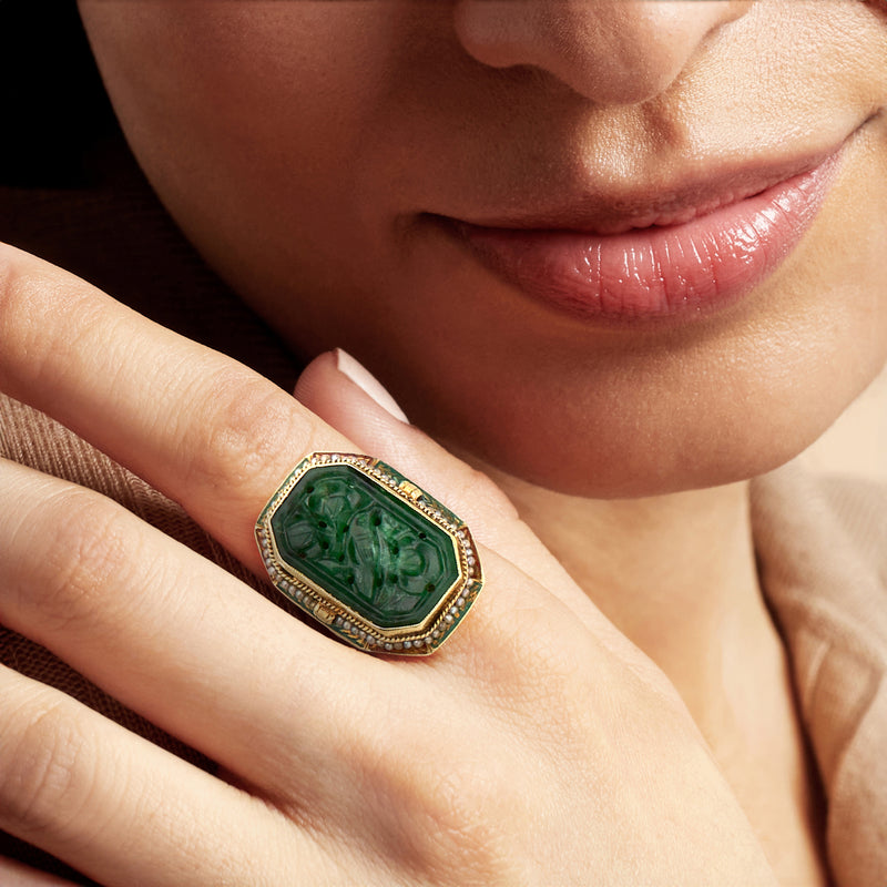 Green jade statement ring on finger, gold bezel with seed pearls and multicolor enamel