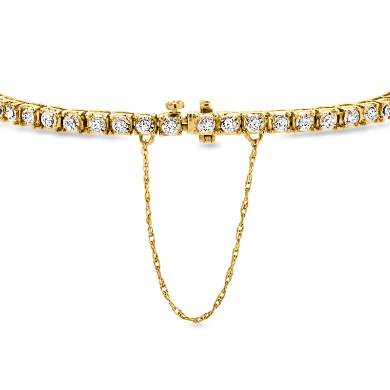 Yellow gold diamond tennis bracelet close-up with box clasp and safety chains