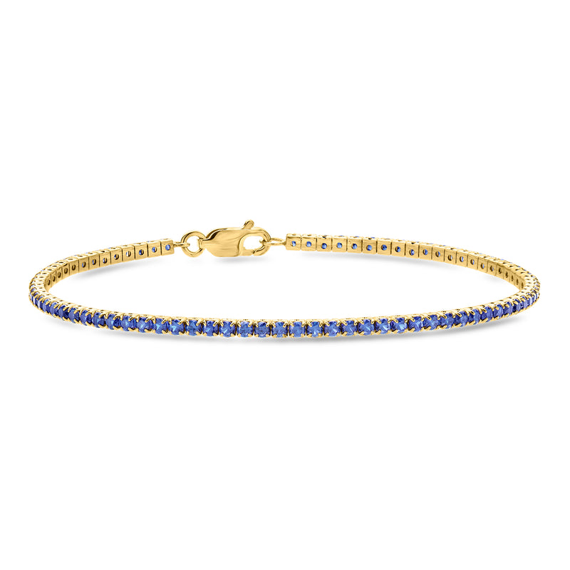 Gold tennis bracelet with blue sapphire row and hinged clasp