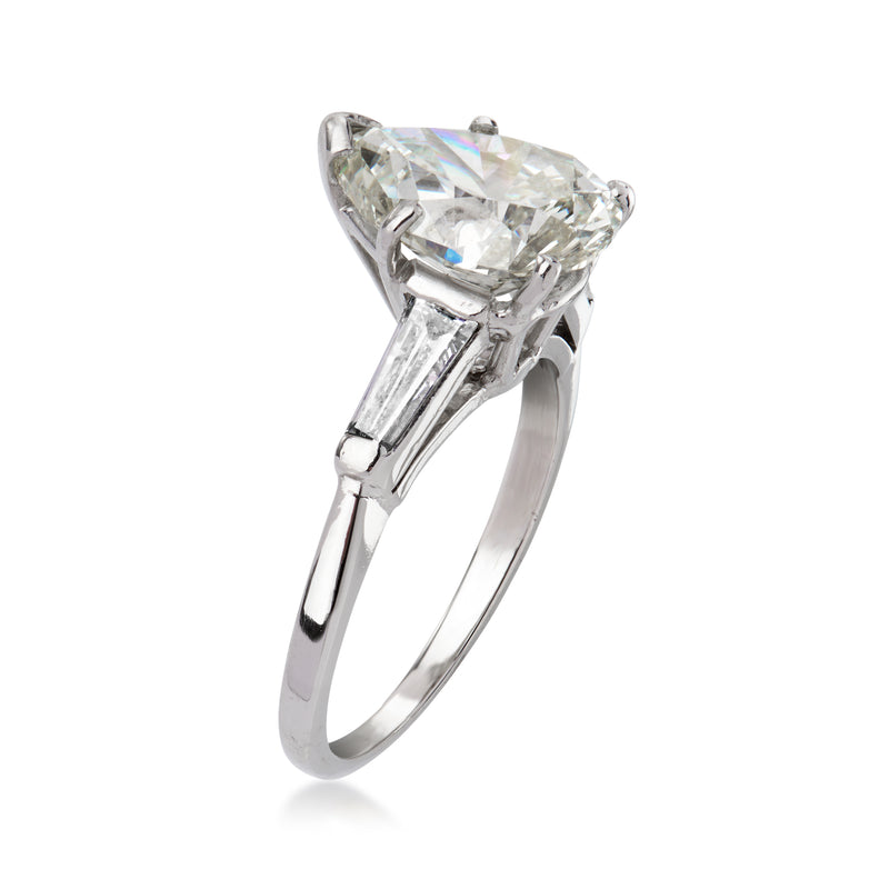Platinum vintage diamond ring angled view with cushion-cut center and baguette accents