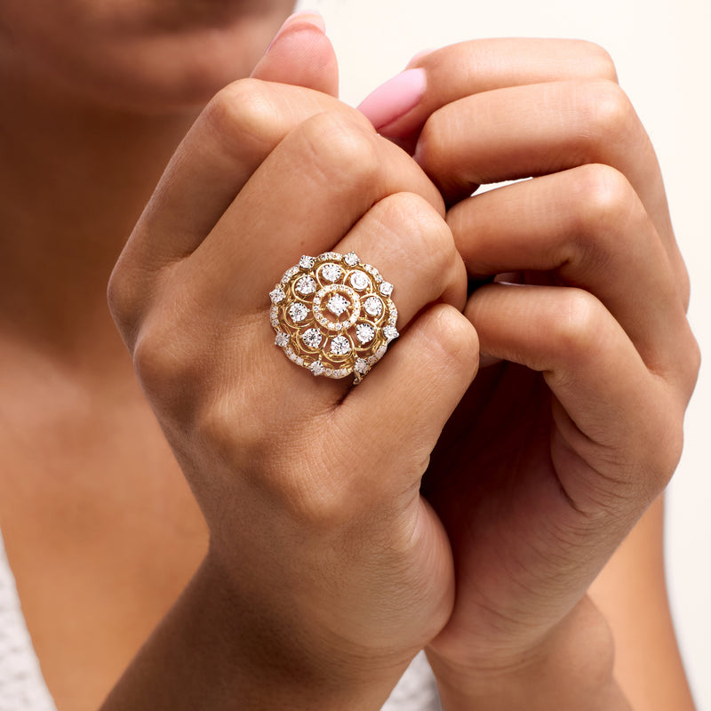 Yellow gold diamond flower ring on hand, round stones in clustered circular setting
