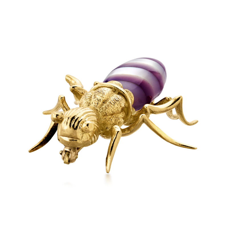 Gold insect brooch pin with purple striped oval body and detailed winged legs