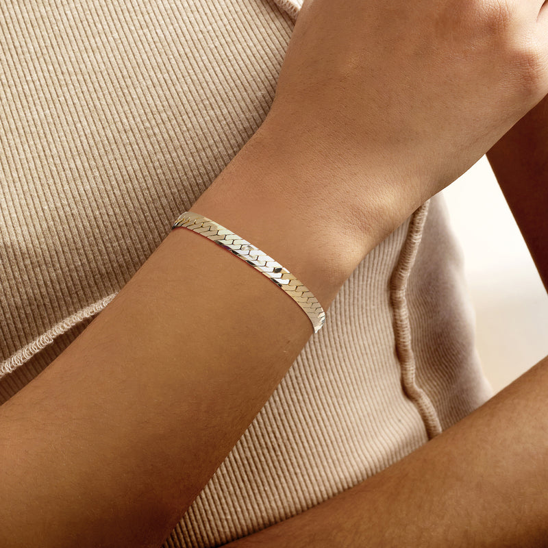 14kt yellow gold herringbone bracelet on wrist with slim box clasp