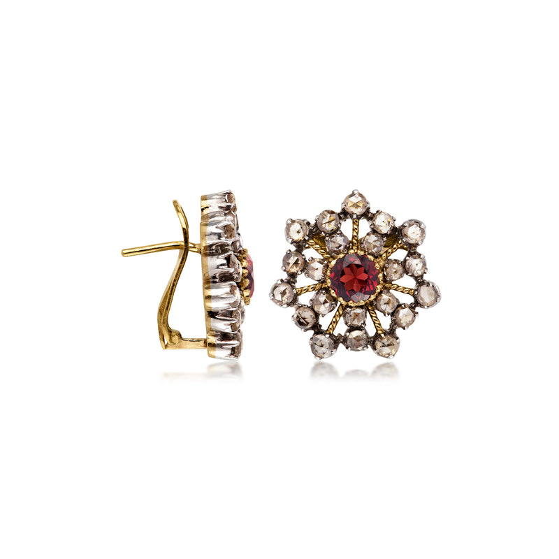Gold-tone snowflake earrings, side view: hinged back with red center and clear stones
