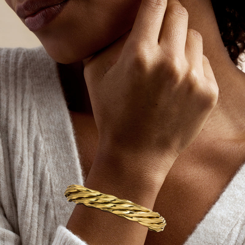 Twisted 18kt gold over sterling bracelet with braided links on wrist
