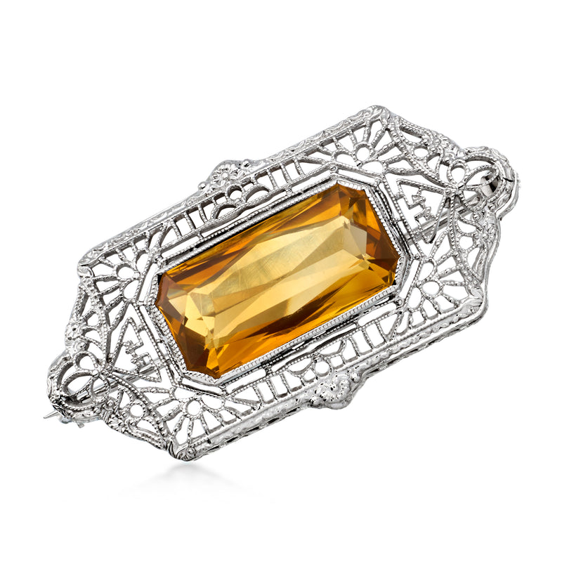 Vintage openwork pin with rectangular orange-yellow gemstone in white gold setting