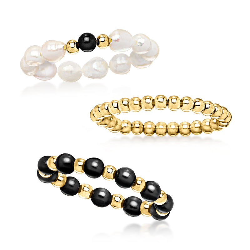 Set of three stretch rings: white pearl band, black onyx bands, and 10kt yellow gold
