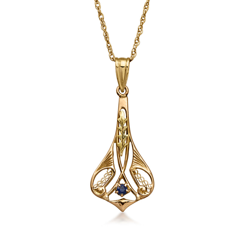 Vintage yellow gold pendant necklace with blue sapphire in filigree setting
