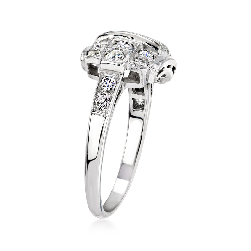 Platinum vintage diamond ring with raised top and side prong-set stones, size 6