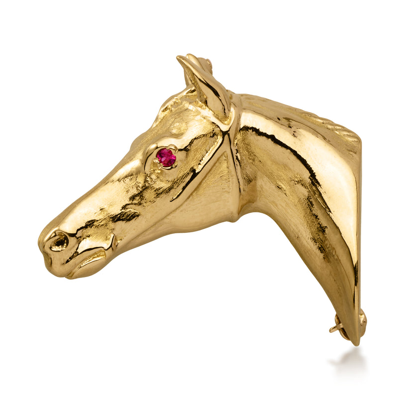 Gold horse head pin with a single ruby eye, vintage 14kt style