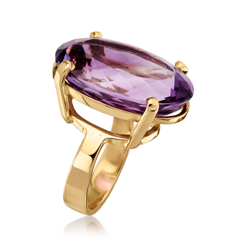 Side view of oval amethyst ring in yellow gold with prong setting