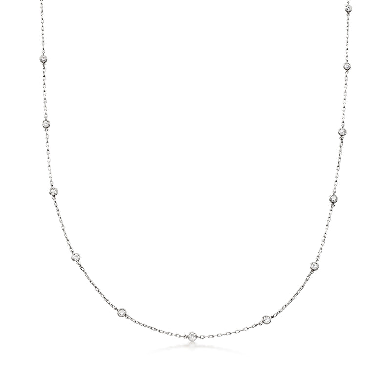 Platinum diamond station necklace with bezel-set round diamonds along a fine chain