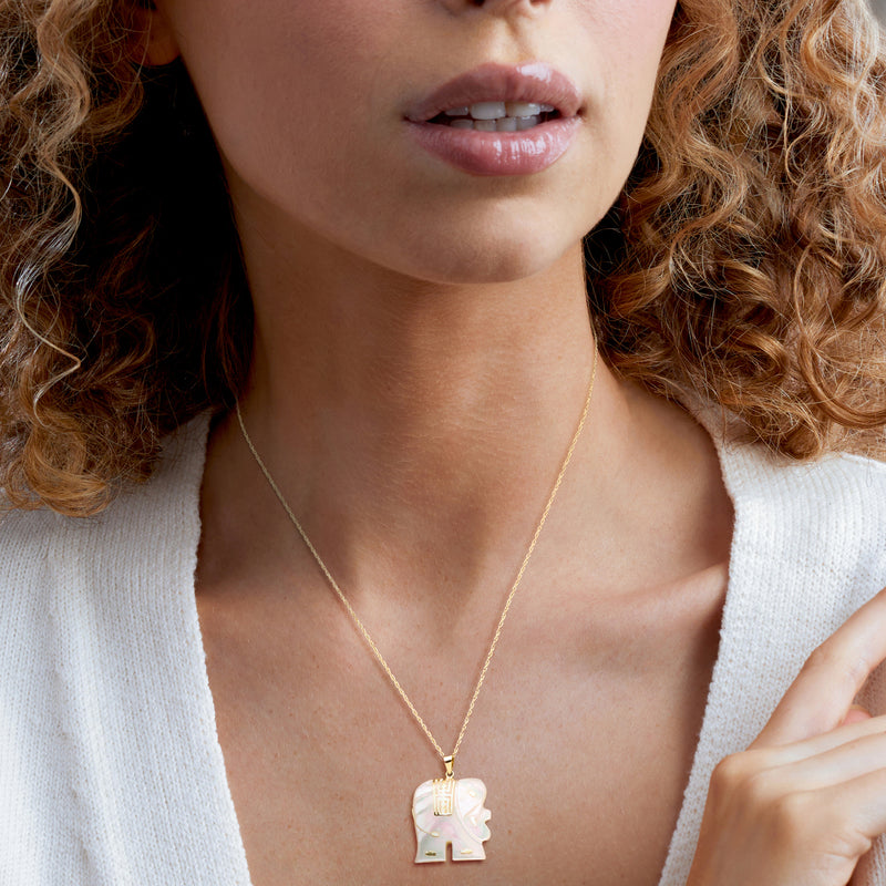 Elephant pendant necklace in mother-of-pearl with 14kt yellow gold setting, worn