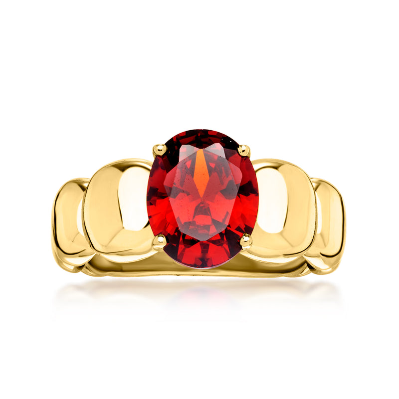 Yellow gold-plated ring with oval red simulated garnet center and four prong setting