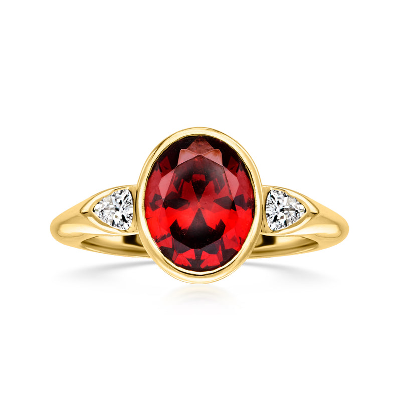 Gold-plated ring with oval red gemstone center and two side CZ accents