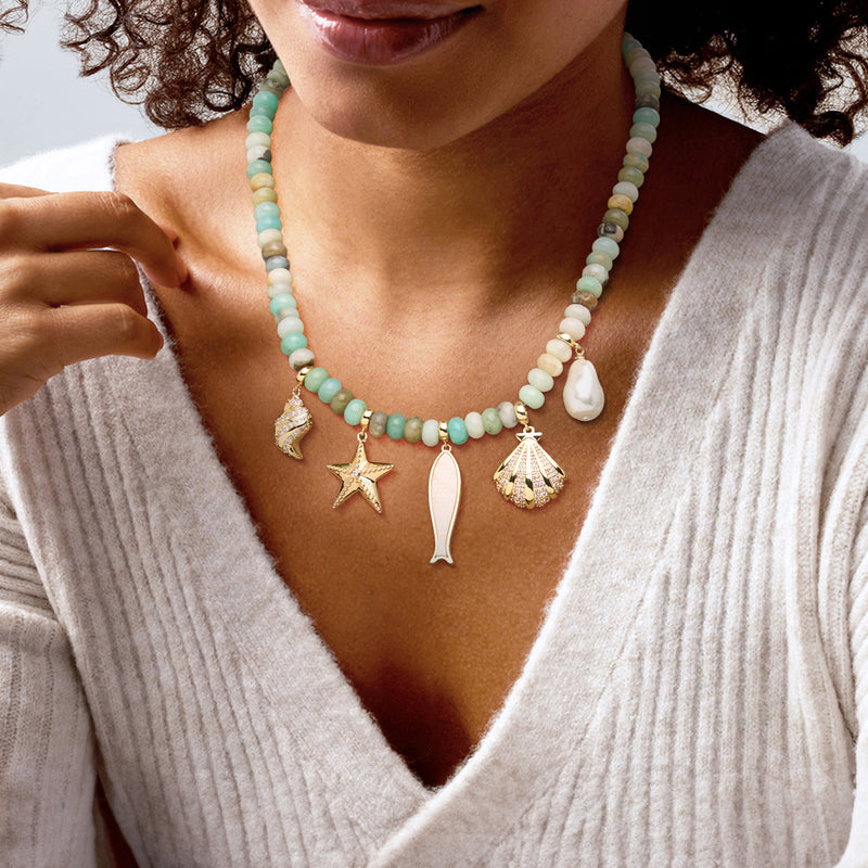 Gold-plated sea-life bead necklace with pearl drop and starfish, conch, star charms