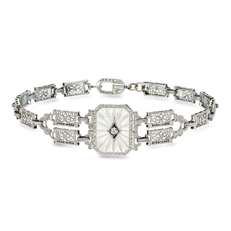 White gold tone vintage filigree bracelet with center stone and rectangular link panels