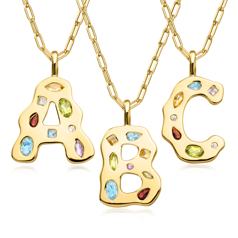Gold-tone initial pendant necklace with multi-color gemstone inlay on letter A and C