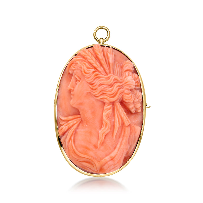 Oval coral cameo pendant in 14kt yellow gold with left-facing profile and bail loop.